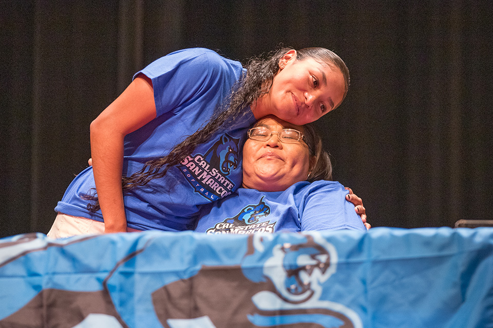 A teen girl hugs her mom